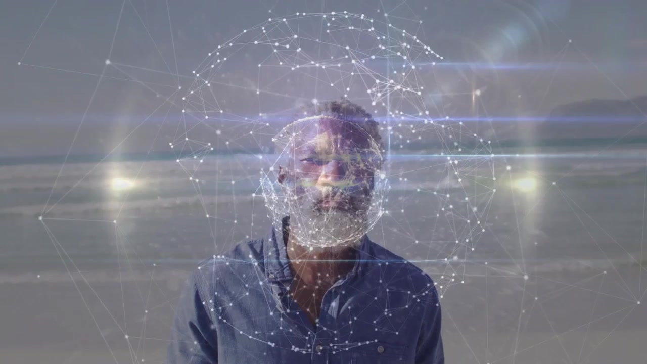 Vertical video: Forming hologram intensifying around mature man on beach, light streaks, blue shirt