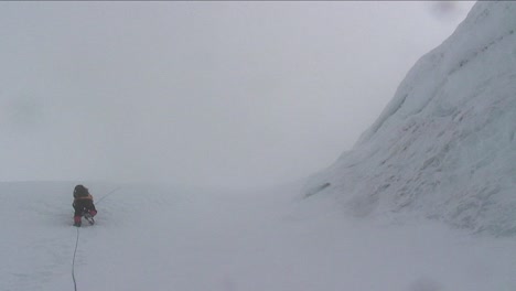 Climber-climbing-past-large-ice-wall