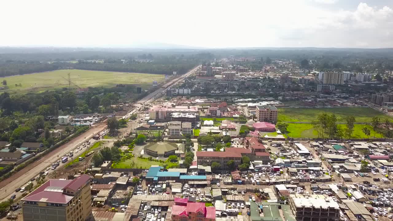 Aerial footage flying over low-rise residential neighborhoods and skyline Nairobi Kenya, changing urban landscapes Kenya Africa