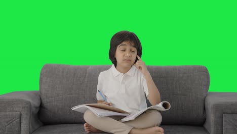 Confused-Indian-boy-reading-and-studying-Green-screen