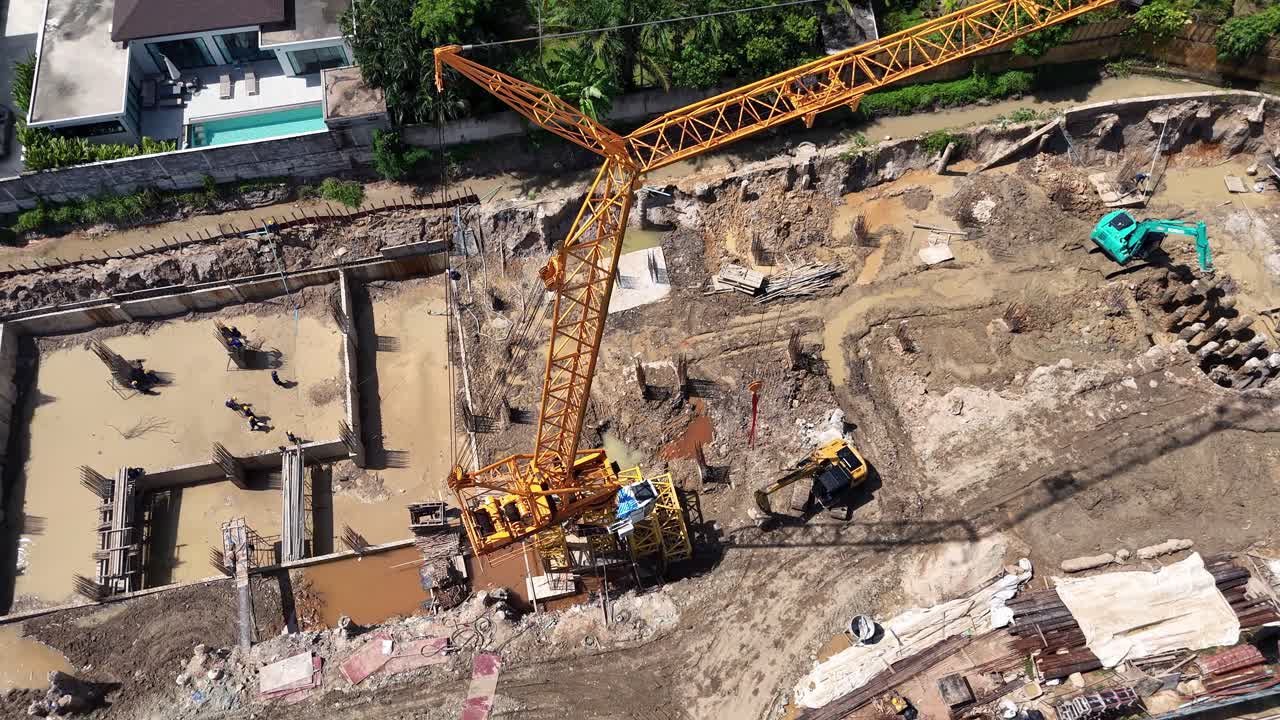 Aerial View of a Large Construction Site with Crane and Excavation Work