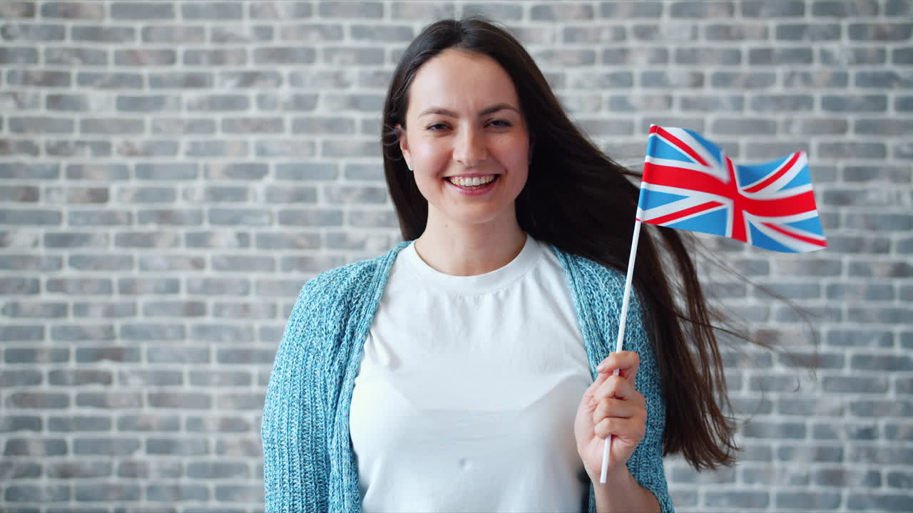 Woman smiling and holding the British flag