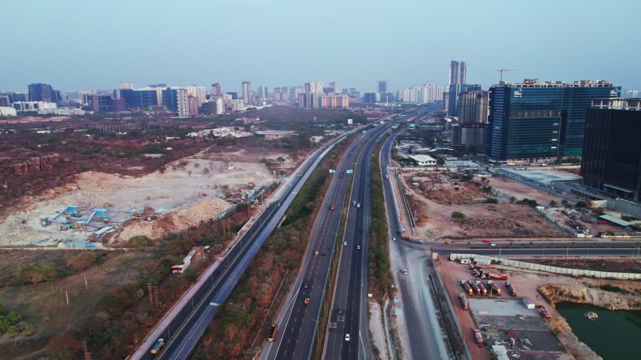 concrete mining with Glass facade buildings and hyderabad outer ring road at day time, semi circle, drone shot, 4k.