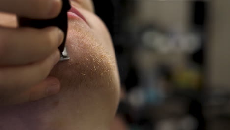 man getting his beard trimmed