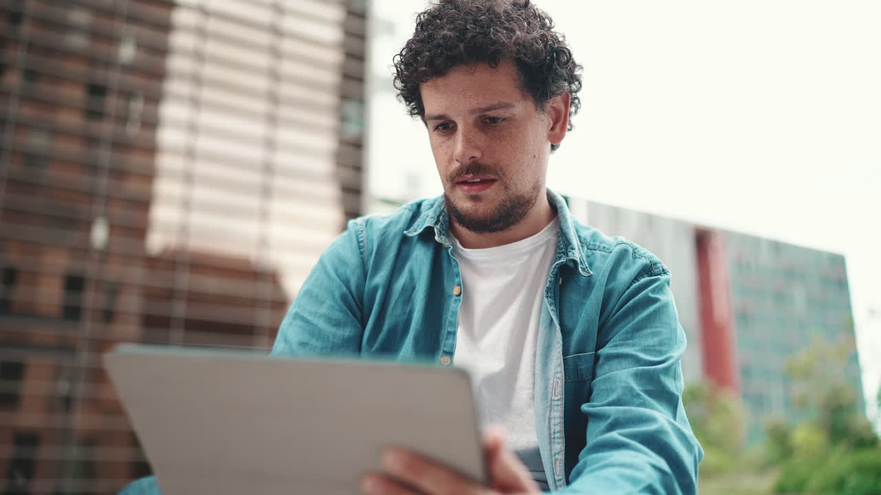 Man Using Laptop in Urban Setting