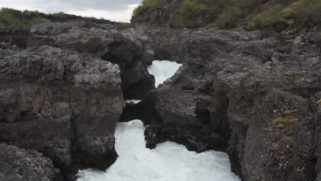 Tilting-and-panning-from-top-right-to-lower-left-of-amazing-waterfall-Barnafoss-in-Iceland