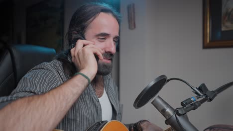 musician on a phone call in a home recording studio