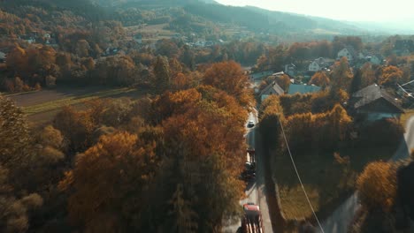 Aerial-shot-of-timber-trucks-convoy-in-autumn-season