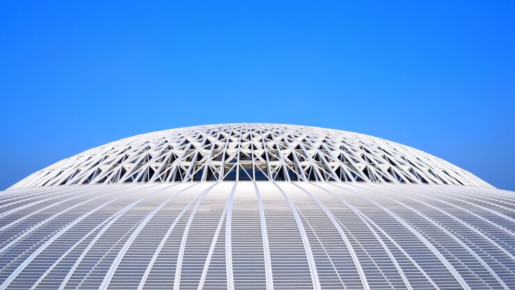 White Lattice Dome Under Blue Sky Showcasing Parametric Geometry, Sweeping Roof Ribs, Crisp Shadows, Minimal