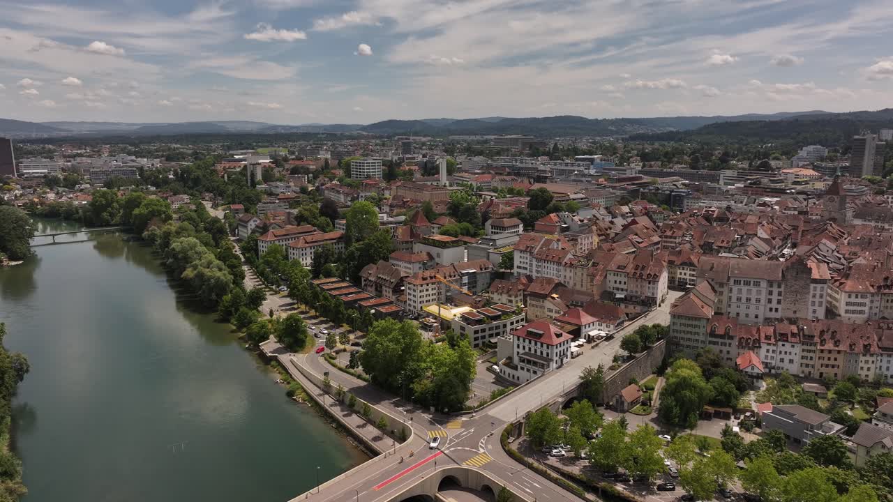 aerial - river bends around historic rooftops and central church in aarau aargau switzerland