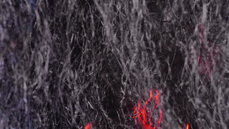 extreme close-up of steel wool with glowing fire moving behind