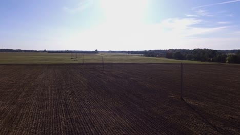 Power-Supply-Pole-Lines-In-Harvested-Agricultural-Fields-On-a-Sunny-Day