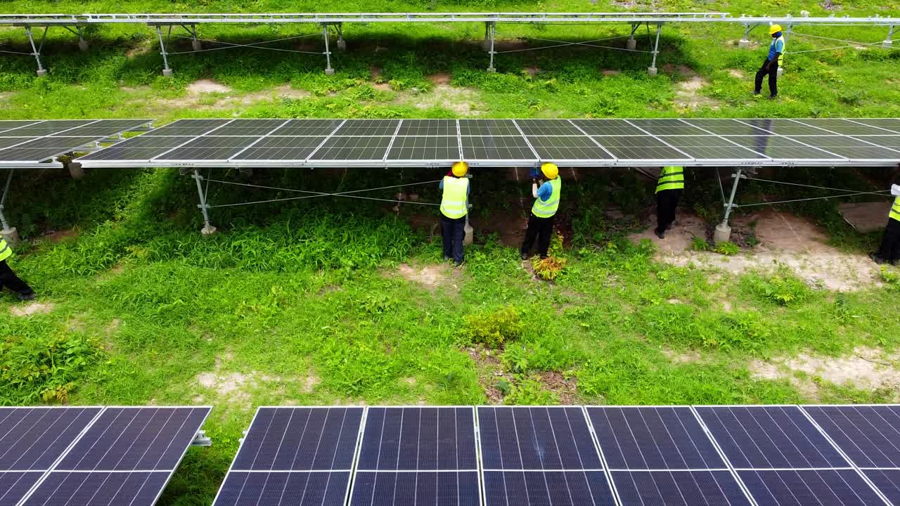 Workers Installing Solar Panels at a Solar Farm