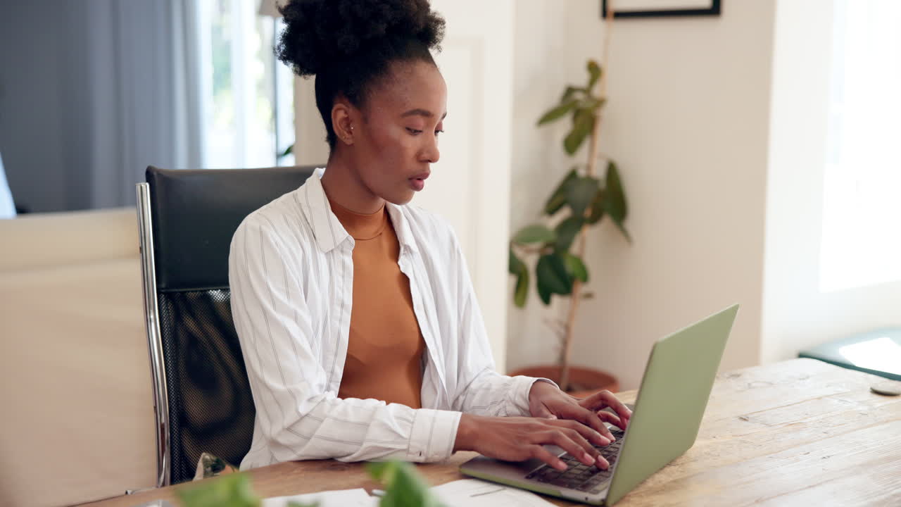 Woman working on laptop at home office