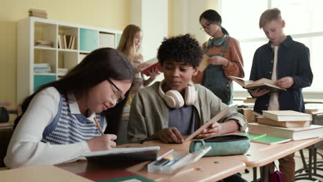 diverse group of students studying and collaborating in a classroom.
