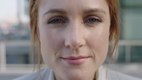 close up portrait of beautiful red head business woman looking up at camera slow motion smiling confident real people series