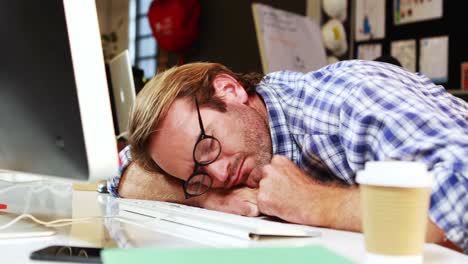 man sleeping at his desk