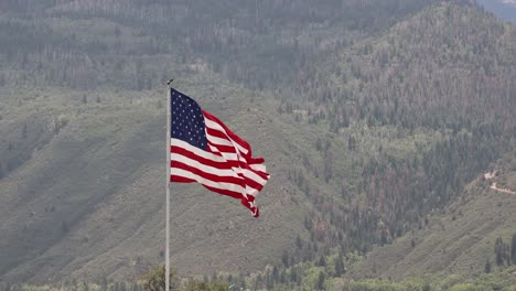 large american flag waving in the wind the san juan mountains in background