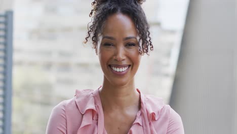 Portrait-of-happy-african-american-businesswoman-in-creative-office