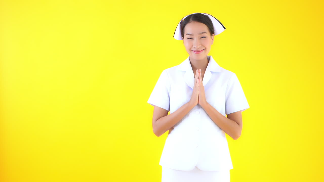 A young woman in a traditional nurse's cap and uniform hands raised in the praying position, Copy space