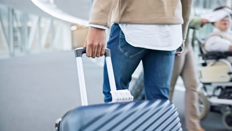 back, walking and hands on suitcase in airport to