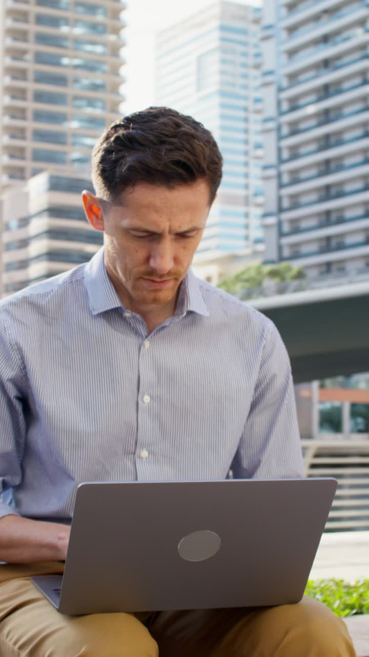 Man working on laptop in the city