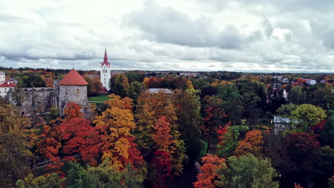 drone shot flying over cesis town in latvia with the church and castle