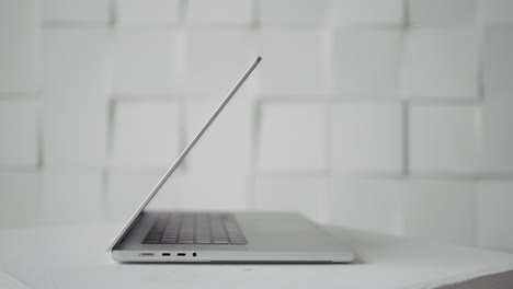 silver laptop on a white surface