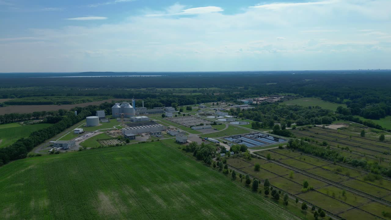 Wastewater treatment plant aerial view, demonstrating water purification process, ensuring environmental sustainability and resource management. Smooth aerial view flight descending drone