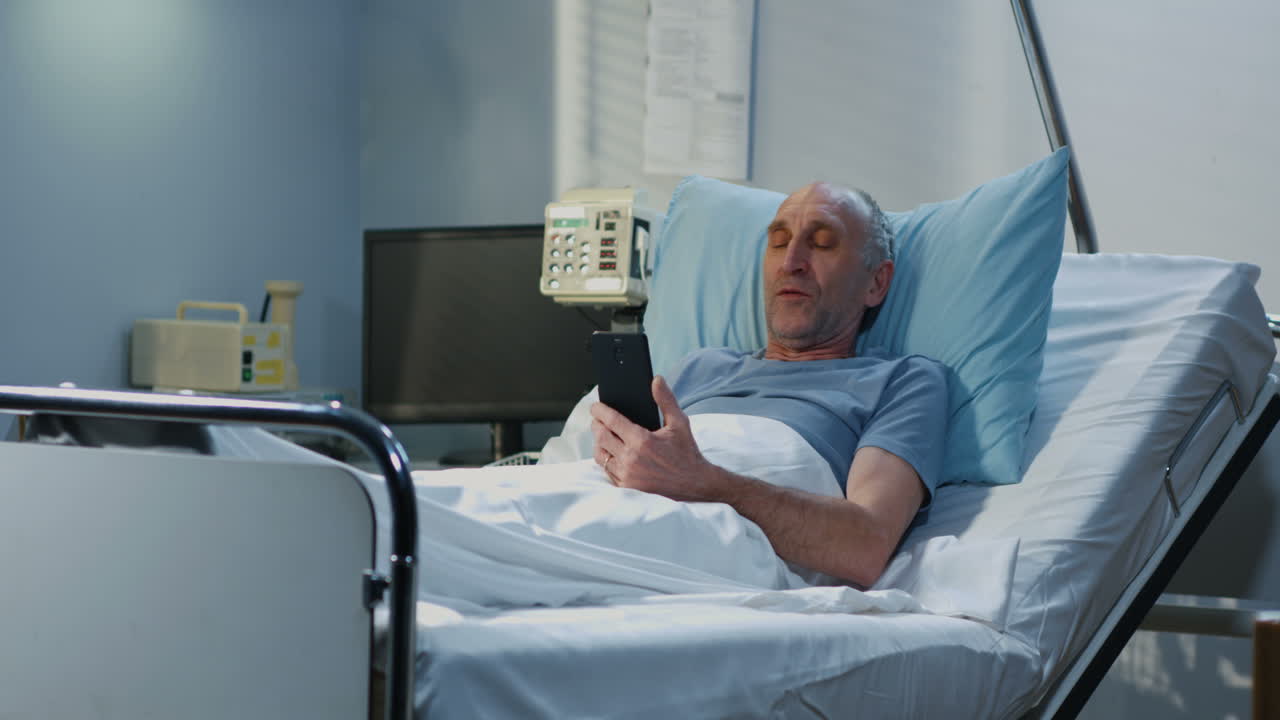 Patient having a video call in hospital room with nurse.