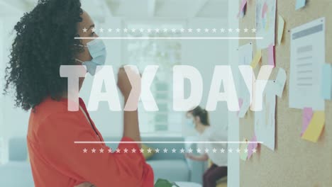 tax day text banner against african american woman reading memo notes at office