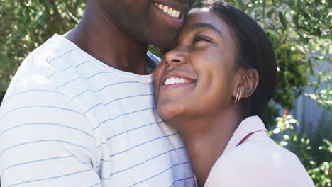 a diverse couple shares a joyful embrace outdoors