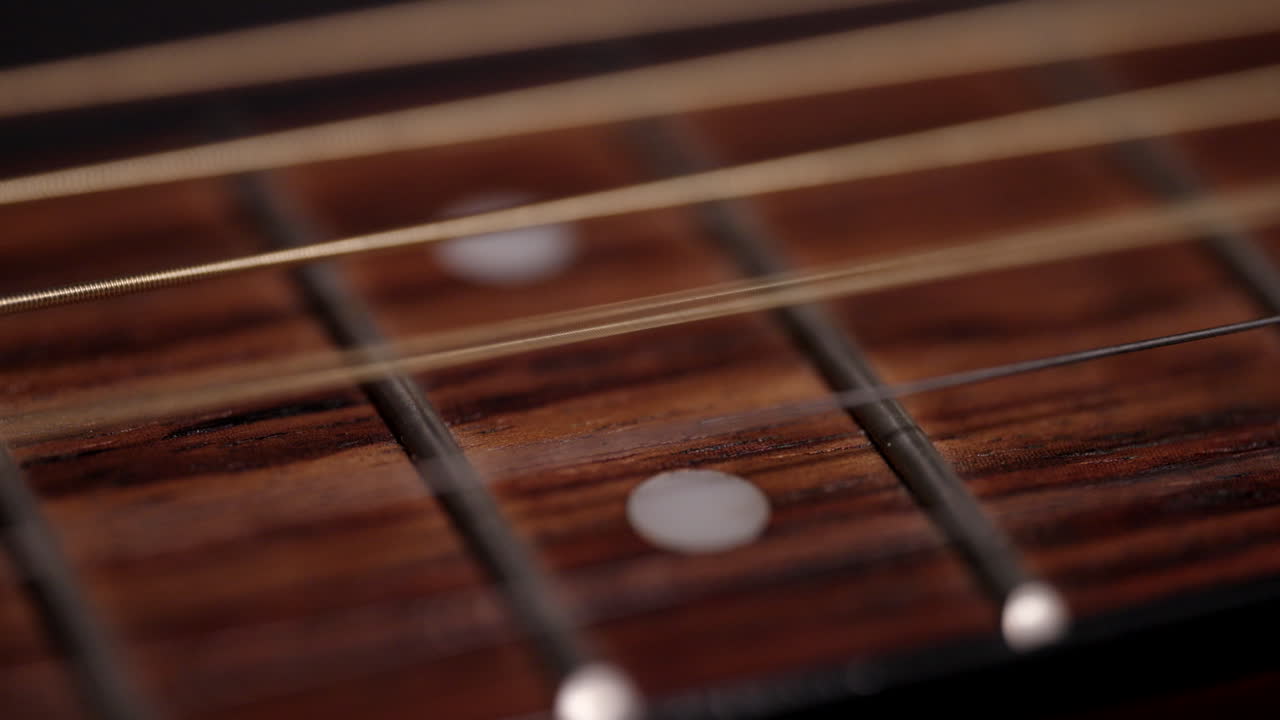 A guitar string vibrates in slow motion after being plucked