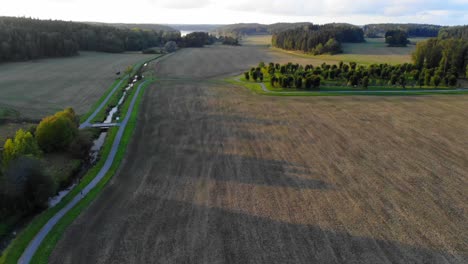 Drone-footage-over-a-field-in-Upplands-Väsby,-Sweden