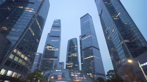a dynamic urban landscape at dusk featuring modern skyscrapers towering against a twilight sky, illuminating the city with architectural brilliance and innovation