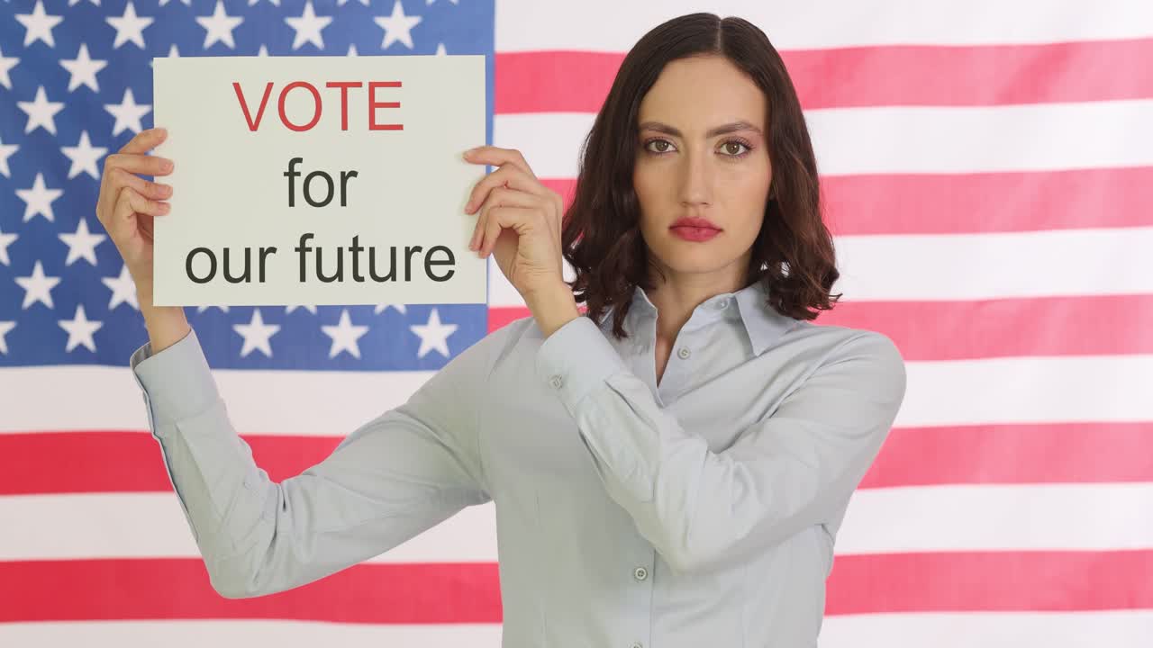 Woman holding 'Vote for our future' sign in front of American flag