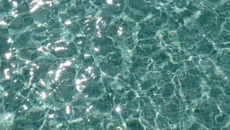 swimming pool water surface with light reflections, background