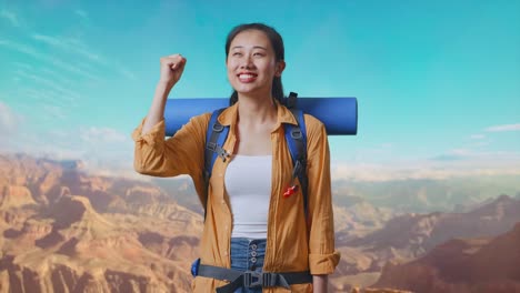 asian female hiker with mountaineering backpack screaming goal celebrating the success while traveling at the top of mountain