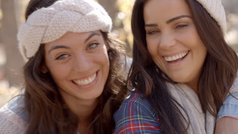 head and shoulders shot of happy lesbian couple in a forest