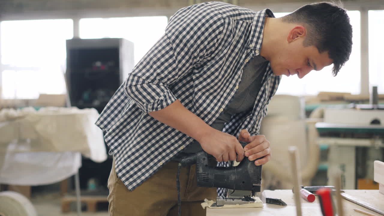 Man Using Jig Saw in a Workshop