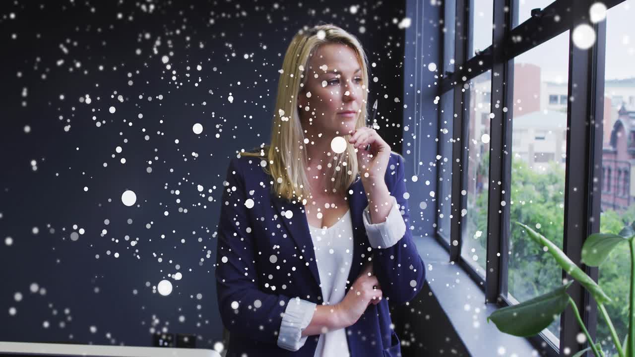 Woman standing at window in business office, pondering while particles appearing, obscuring scene