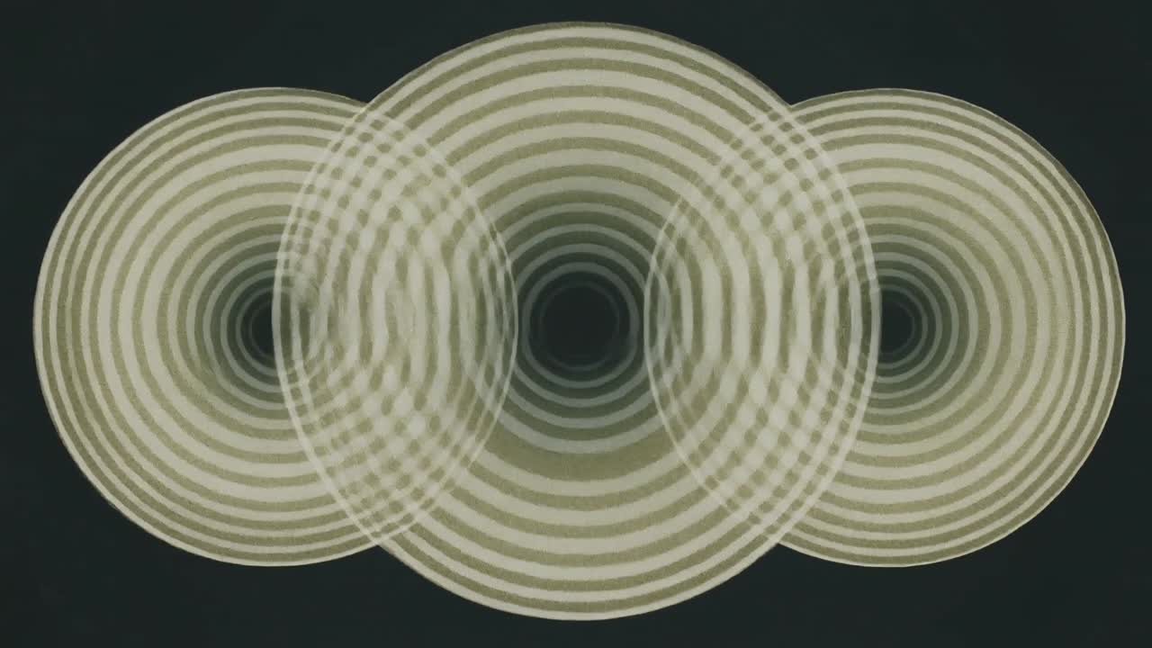 Vertical video: Playing three concentric rings sliding laterally on dark backdrop, reducing moire