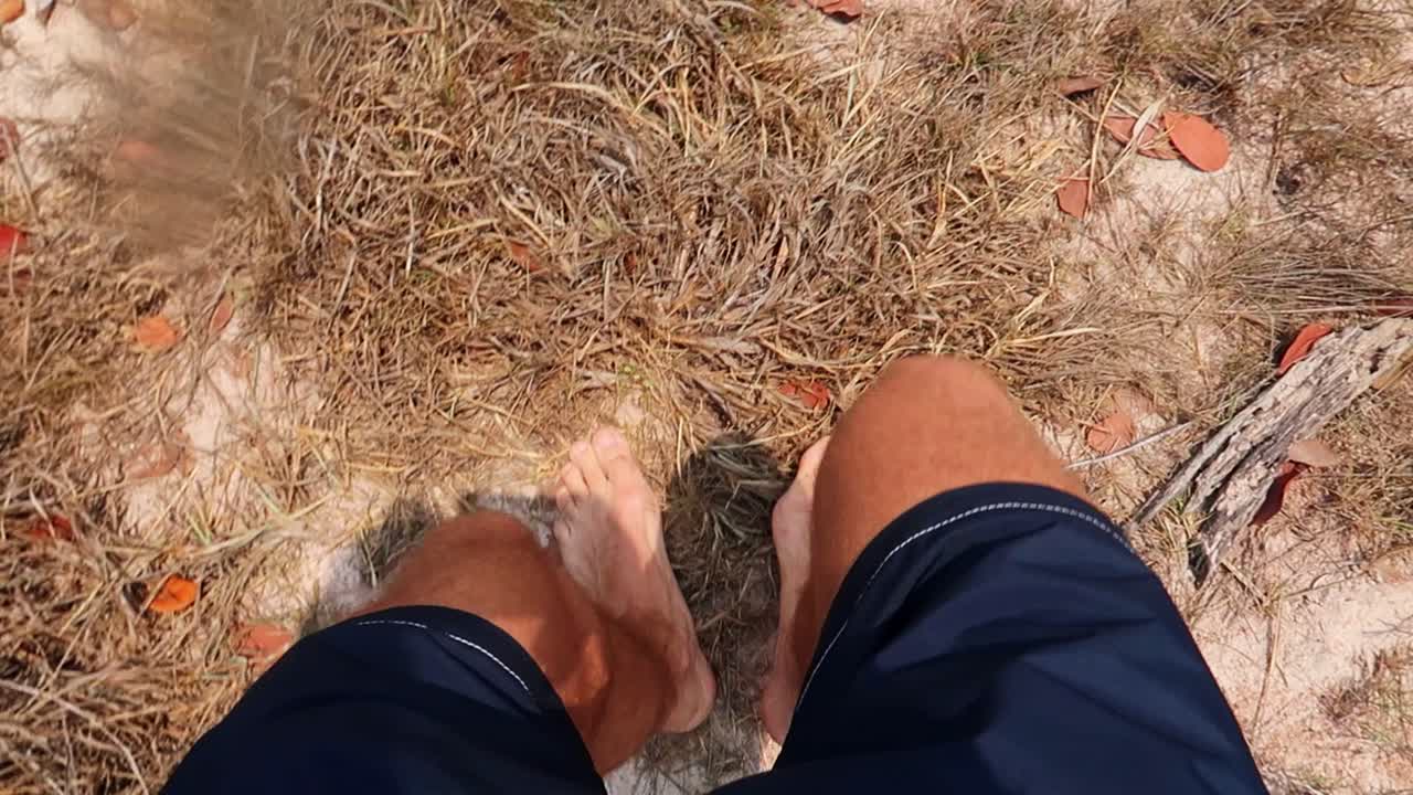 남자는 바다 해안선의 바위 절벽으로 내려갑니다.