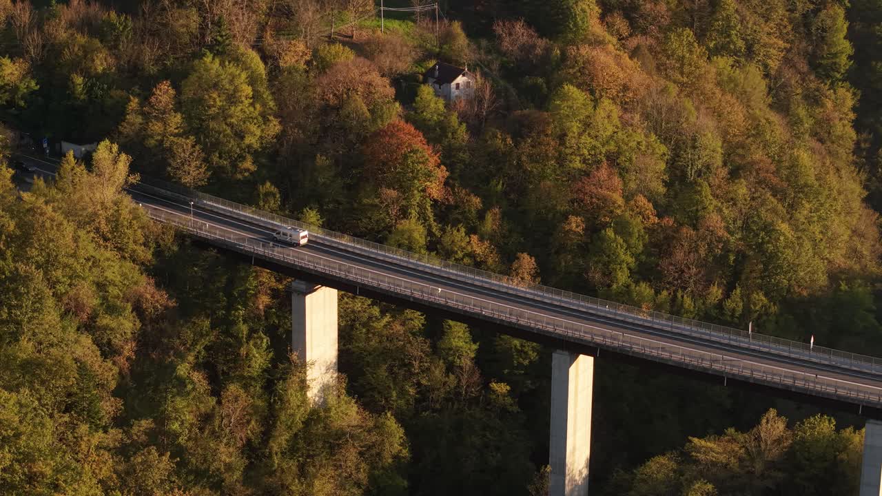 Aerial View of a Highway Bridge Crossing a Forest in Autumn