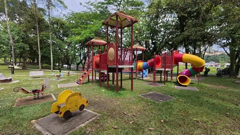 a vibrant public playground for children in a beautiful tropical park. sunny weather enhances the cheerful outdoor atmosphere