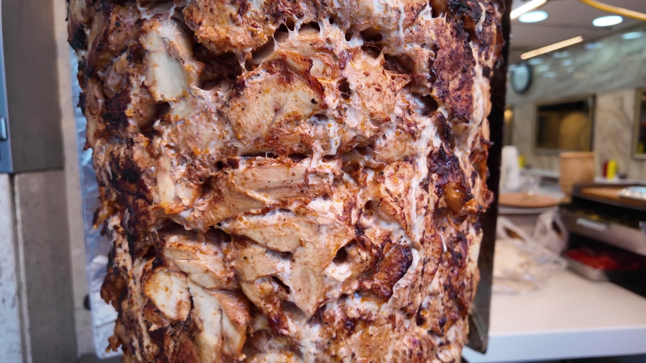 Appetizing Grilled Chicken Shawarma Meat on a Rotisserie