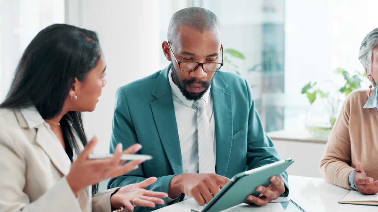 Business team collaborating on tablet in modern office