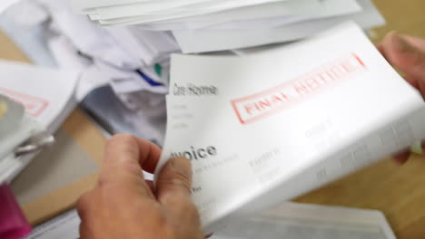 close up of a man opening debt letters