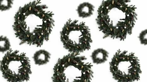 a stream of christmas green spruce wreath over of different diameters diameters on a white color background. 4k uhd footage. futuristic design, motion design animation. pop art design, creative christmas sweets food concept