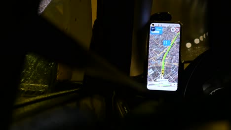 smartphone gps navigation app in a car at night